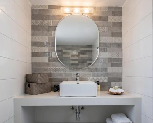 a bathroom with a sink and a mirror at Casa Thea in Archangelos