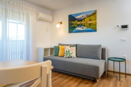 a living room with a couch and a table at Start Point Apartments in Žirovnica