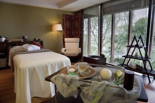 a bedroom with a bed and a table with food on it at Santana Hotel & SPA in Vila do Conde