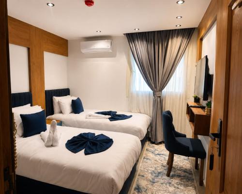 a hotel room with two beds and a television at The Grand Delta Hotel in Cairo
