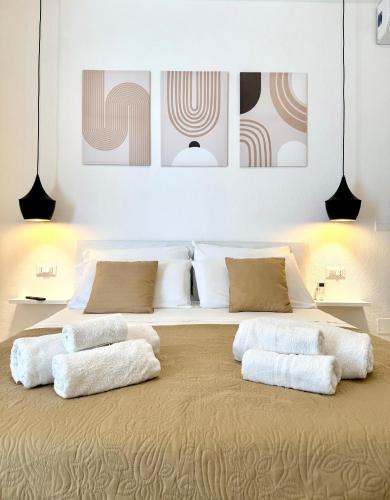 a bedroom with a large bed with four pillows at S'Olivare Posada - Apartments in Posada