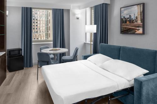 a hotel room with a bed and a table at Four Points by Sheraton New York Downtown in New York