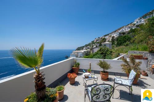 a balcony with chairs and a view of the ocean at Casa Francisca in Praiano