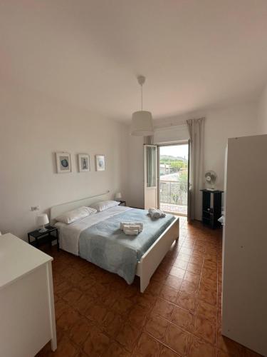 a bedroom with a bed and a large window at Casa Lea - Sperlonga in Sperlonga