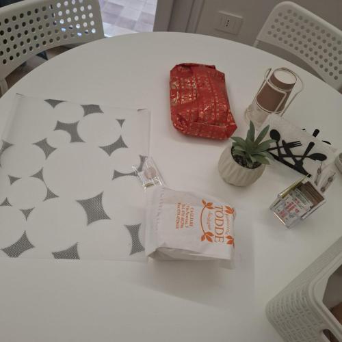 a white table with a bag and a plant on it at Mary's Sweet Home in Cagliari