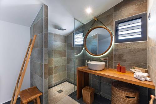 a bathroom with a sink and a mirror at L'Astrolabe in Vieux-Fort