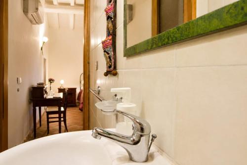 a bathroom with a sink and a mirror at Etna 1928 Country House in SantʼAlfio