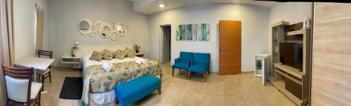 a bedroom with a bed and a table and a television at Ch Loreto Hotel Boutique in Ciudad de Loreto
