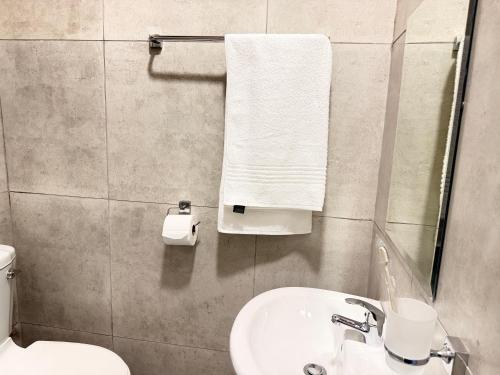 a bathroom with a white sink and a toilet at Rugira Guest House in Vosburg