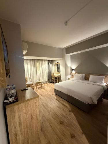 a bedroom with a bed and a desk and a television at Atlas Hotels in Cairo