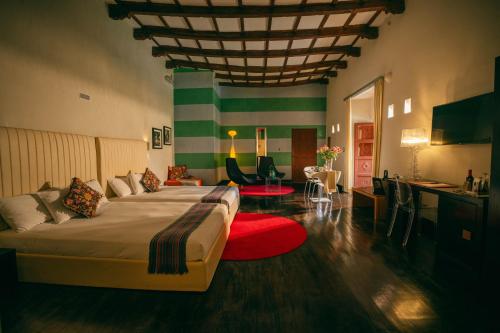 a bedroom with a large bed with a red rug at Casa Cartagena Boutique Hotel & Spa in Cusco