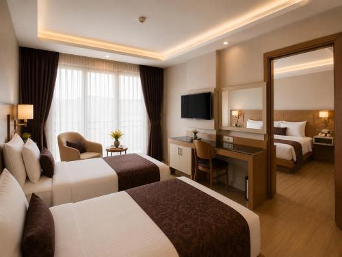 a hotel room with two beds and a desk at Anemon Kent Trabzon Otel in Trabzon