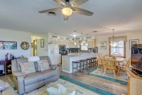 a living room with a couch and a kitchen at 4125 - Sea Dawg in Kitty Hawk
