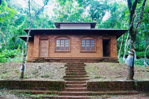 a small house in the middle of a forest at Villa Terra, Spacious 2BR Villa in Kannur