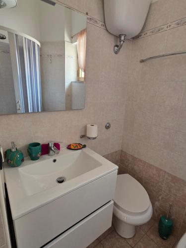 a bathroom with a white sink and a toilet at Casa Murales in Diamante