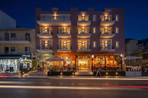 a building with tables and chairs in front of it at Thalyra in Rethymno