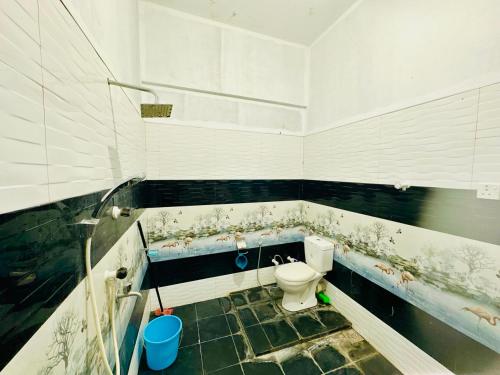 a dirty bathroom with a toilet in a room at Cleopatra villa in Kattankudi