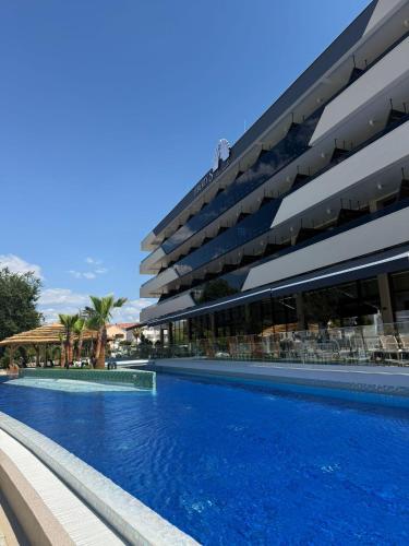 a swimming pool in front of a building at Liberty S Hotel in Novalja