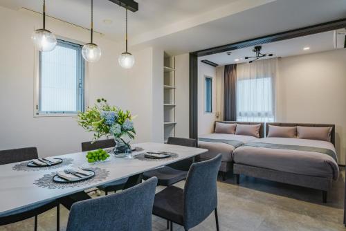 a dining room with a table and a couch at SLL Urban Suites Ebisu in Tokyo