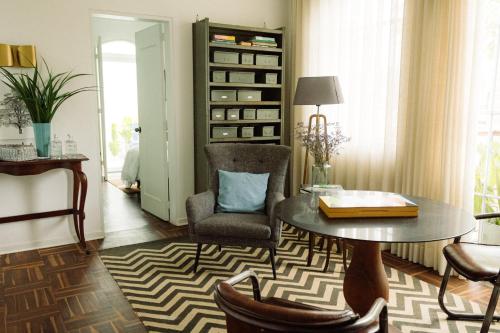 a living room with a table and a chair at Fausto by Andean in Lima