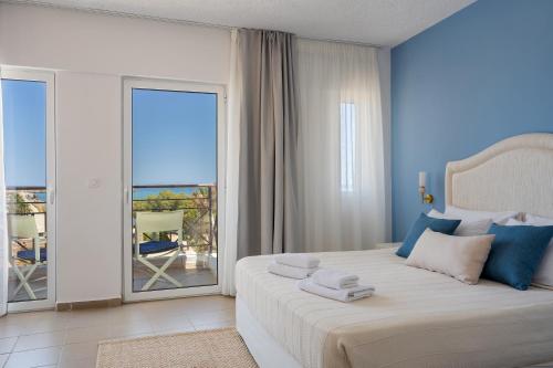 a bedroom with a bed with a view of the ocean at Thalyra in Rethymno