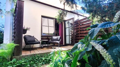 a patio with two chairs and plants at Vinoteegi Residents in Kuressaare