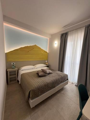a bedroom with a large bed with a large headboard at Quattro Vette in Norcia