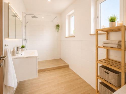 a white bathroom with a sink and a shower at Dill Apartments Pleinfeld Pacellistraße in Pleinfeld