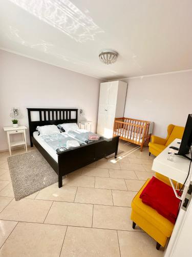 a bedroom with a bed and a desk and a couch at Penzión Lili in Opatovce nad Nitrou