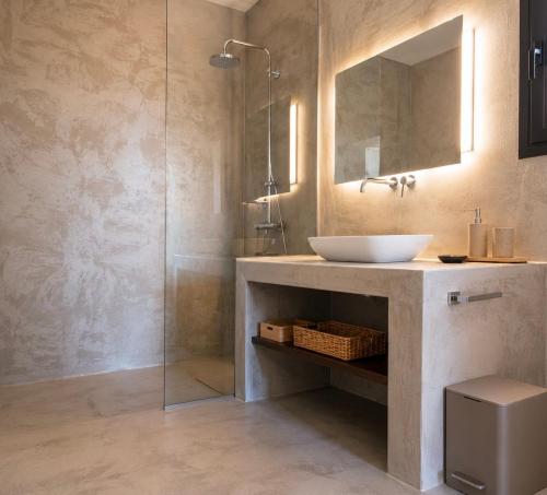 a bathroom with a sink and a glass shower at Villa Melisea in Sfendoúrion