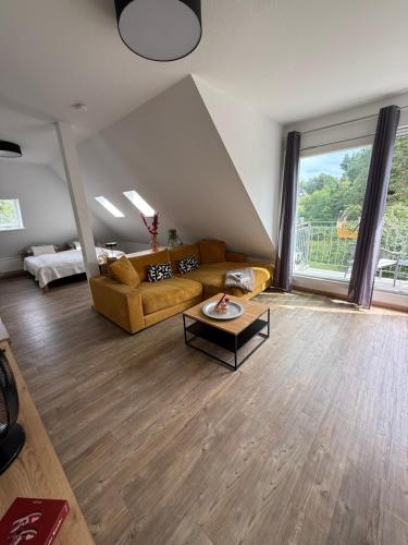 a living room with a couch and a table at Pro Home Mara private Sauna in Bad Oeynhausen