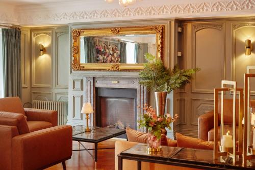 a living room with a fireplace and a mirror at Bunratty Castle Hotel & Leisure Club, BW Premier Collection in Bunratty
