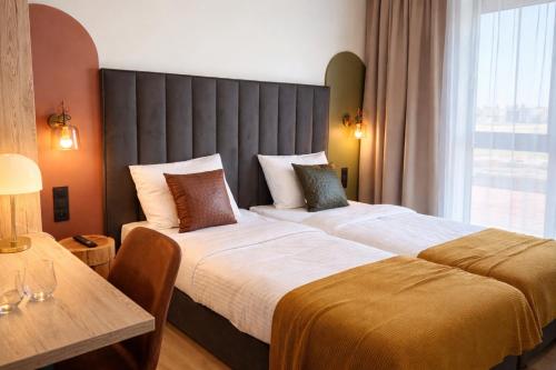a hotel room with two beds and a table at Hotel Evo in Witunia