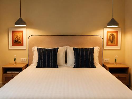 a bedroom with a large bed with two night stands at Hotel "Villa Niche" By Bratheim in Tirana