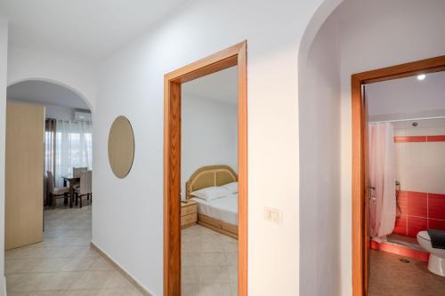 a room with a mirror and a bedroom with a bed at Cloud Nine Retreat, Ksamil in Ksamil