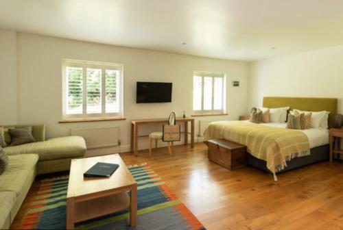 a living room with a bed and a couch at St Enodoc Hotel by Paul Ainsworth in Wadebridge