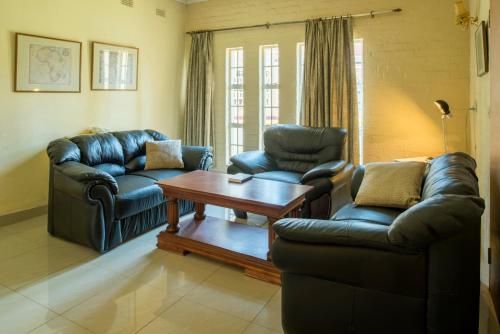 a living room with two couches and a coffee table at Kadoma Hotel & Conference Centre in Katoma