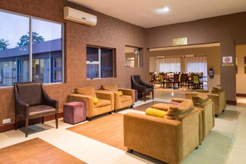 a lobby with couches and chairs and a table at Kadoma Hotel & Conference Centre in Katoma