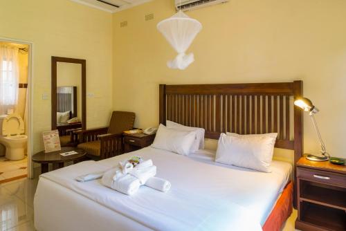 a bedroom with a bed with towels on it at Kadoma Hotel & Conference Centre in Katoma