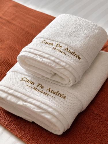 two white towels sitting on top of a table at Casa de Andres Mojácar in Mojácar