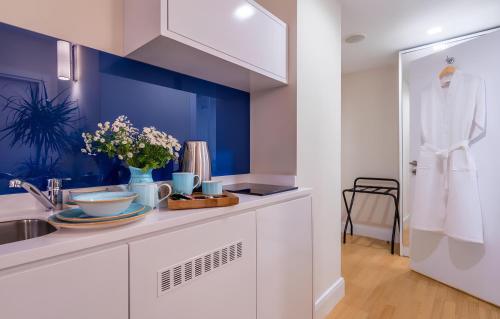 a kitchen with a sink and a white counter top at Panorama Central Batumi in Batumi