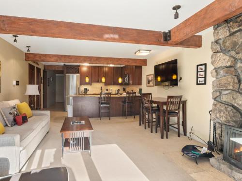 a living room with a couch and a fireplace at Lift One Condominiums - Unit 409 in Aspen