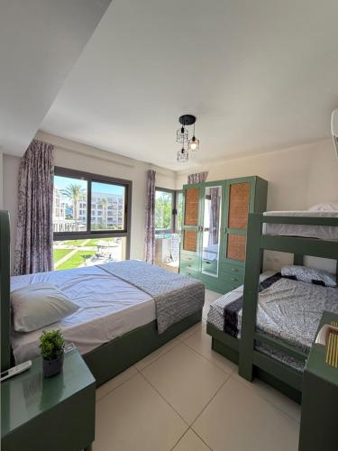 a bedroom with two beds and a window at Chalet in the marassi marina 2 in El Alamein