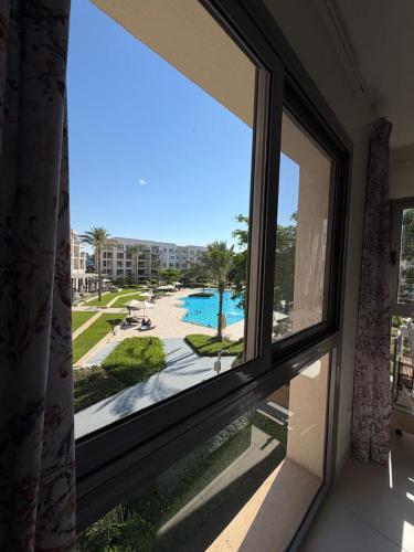 a window in a room with a view of a pool at Chalet in the marassi marina 2 in El Alamein
