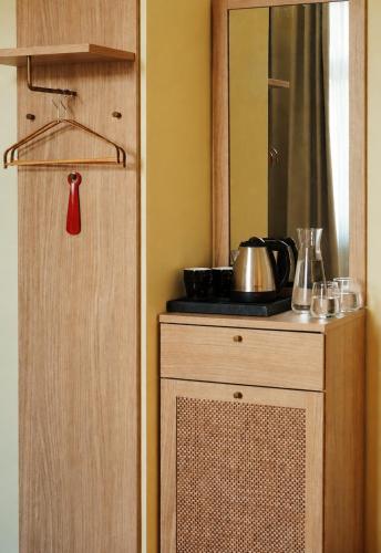 a kitchen with a cabinet with a pot on it at Hotel "Villa Niche" By Bratheim in Tirana