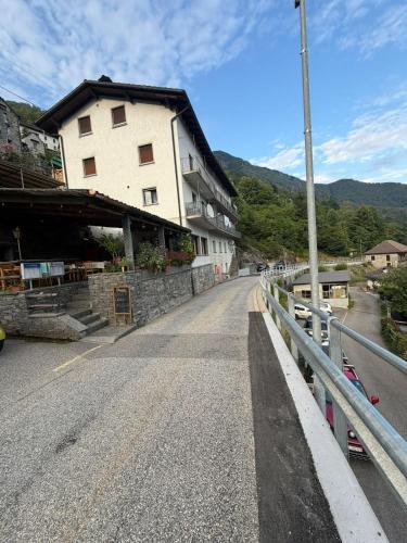 an empty road next to a building on a bridge at La Pergola in Auressio