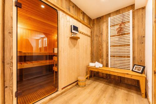 a sauna with wooden walls and a wooden bench at Harzlodge Lebenstraum in Braunlage