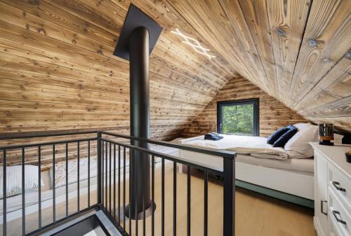 a bedroom in a tree house with a balcony at Forest&Lake Retreat in Dehtáře