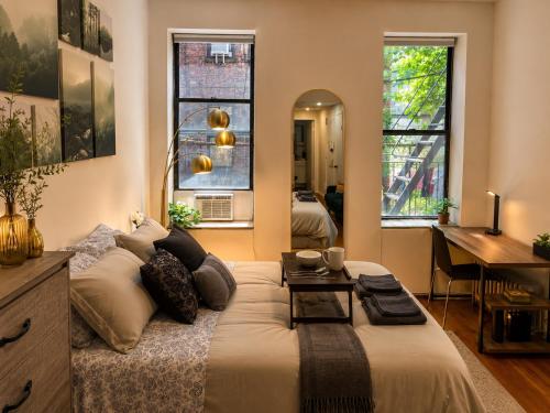 a bedroom with a large bed with a table on it at Union Nest in New York