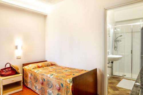 a bedroom with a bed and a bathroom with a sink at Borgo San Giorgio by La Principina in Grosseto